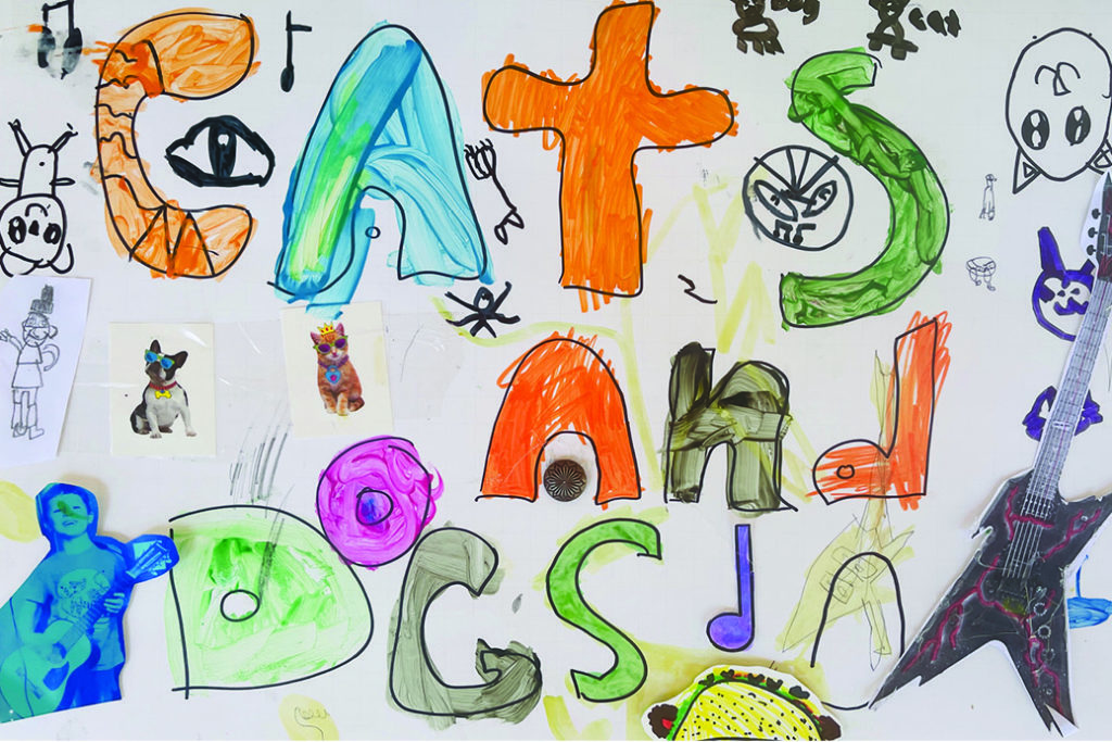 Painted letters spelling Cats and Dogs, with pet stickers and a paper electric guitar