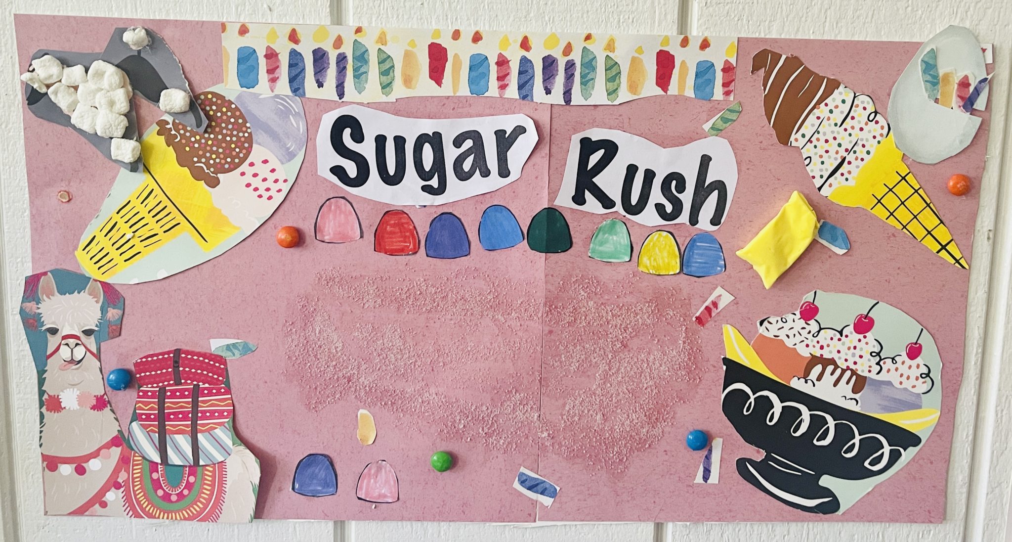 Pink paper collage titled Sugar Rush with ice cream cones, gumdrops, a sundae and a llama